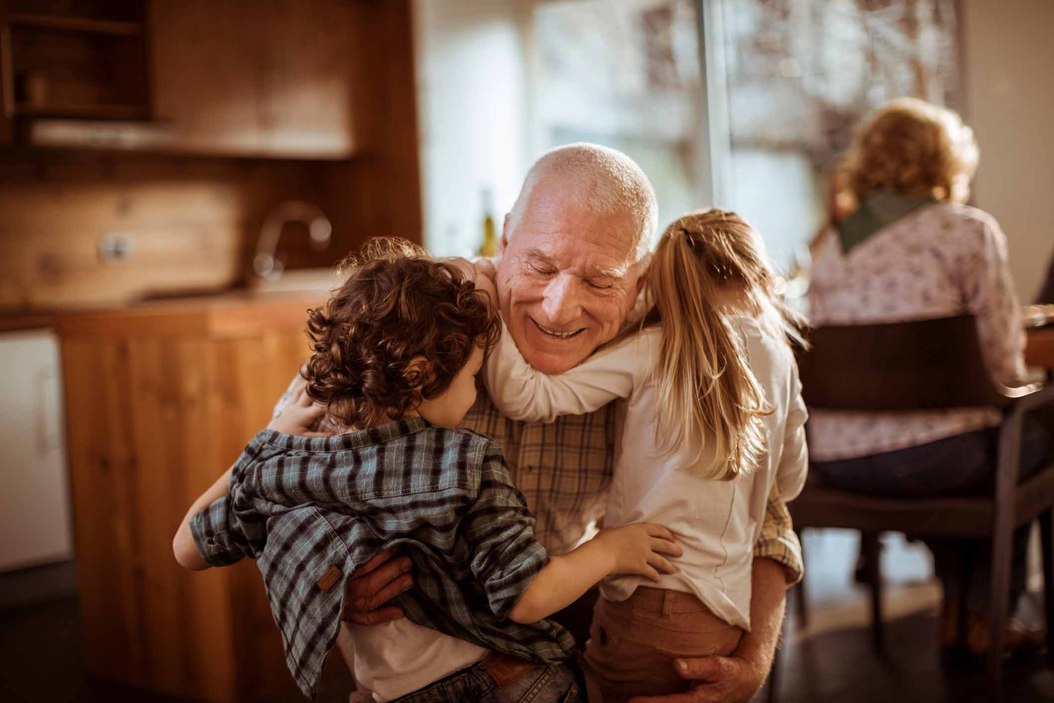 Grandpa hugging grandkids