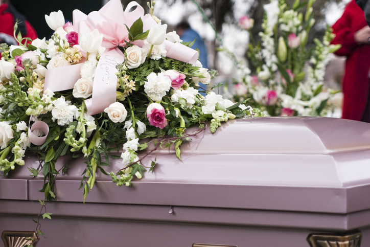 casket with large floral arrangement