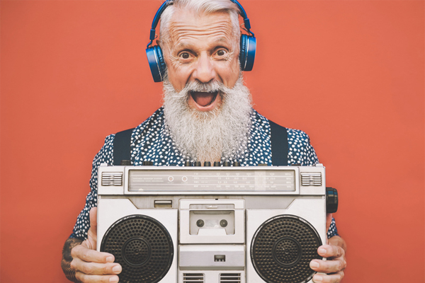 older man listening to music boombox