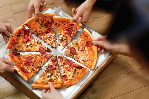 people-grabbing-slices-of-pizza